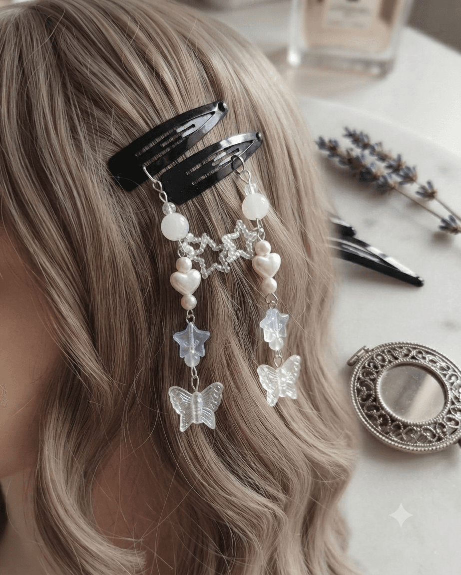 Woman wearing matching black hair clips with white star beads, white hearts and translucent butterfly dangles in her hair.