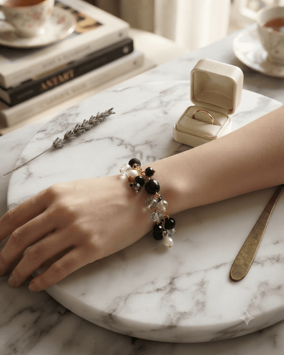 Handmade black and gold-tone beaded chain bracelet displayed with clustered beads and dangling accent details.