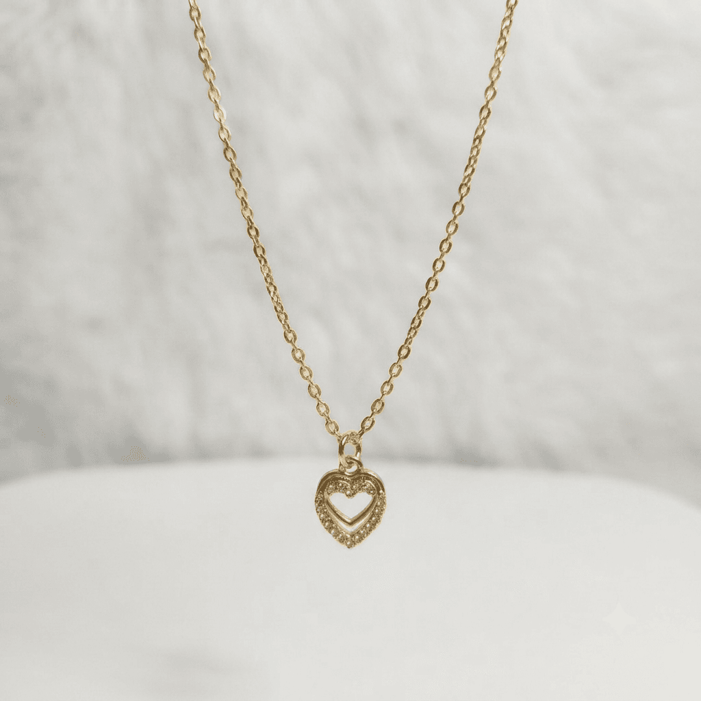 Gold-tone heart pendant necklace displayed against a clean white background