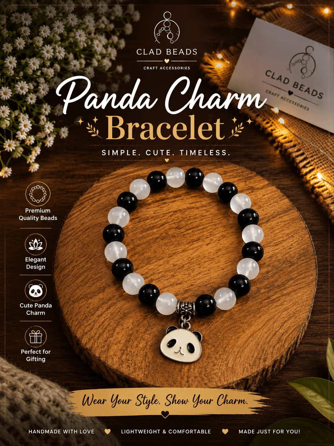 Black and white handmade panda charm bracelet presented in a warm lifestyle setting with a wooden display and greenery.