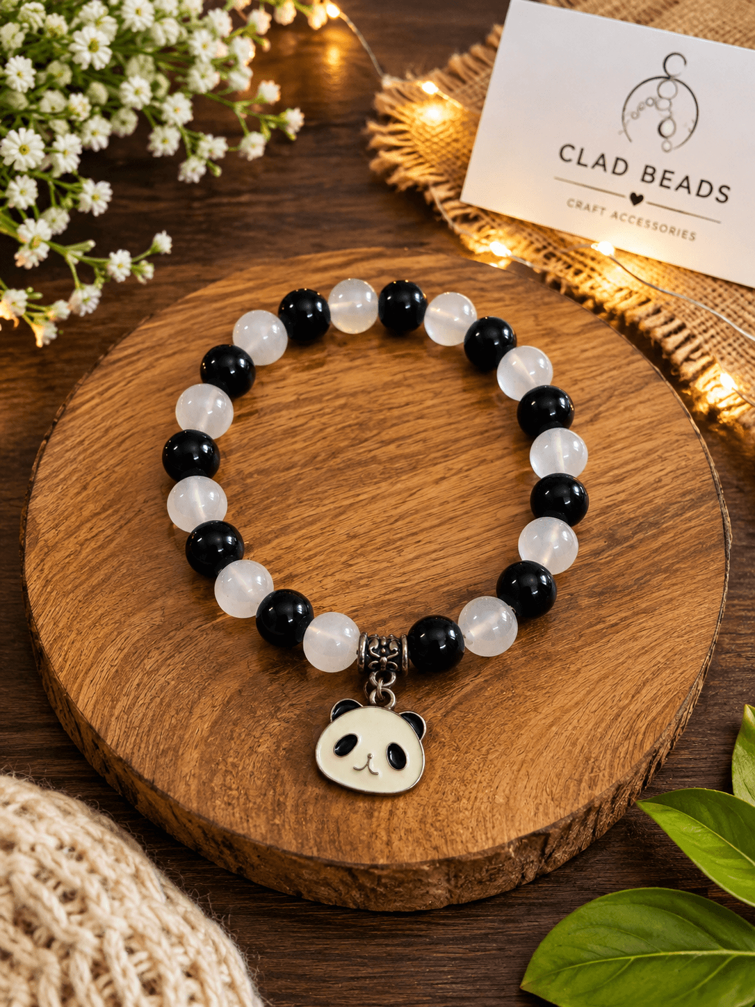 Handmade black and white jelly-style beaded bracelet with a cute panda face charm and decorative centre spacer.