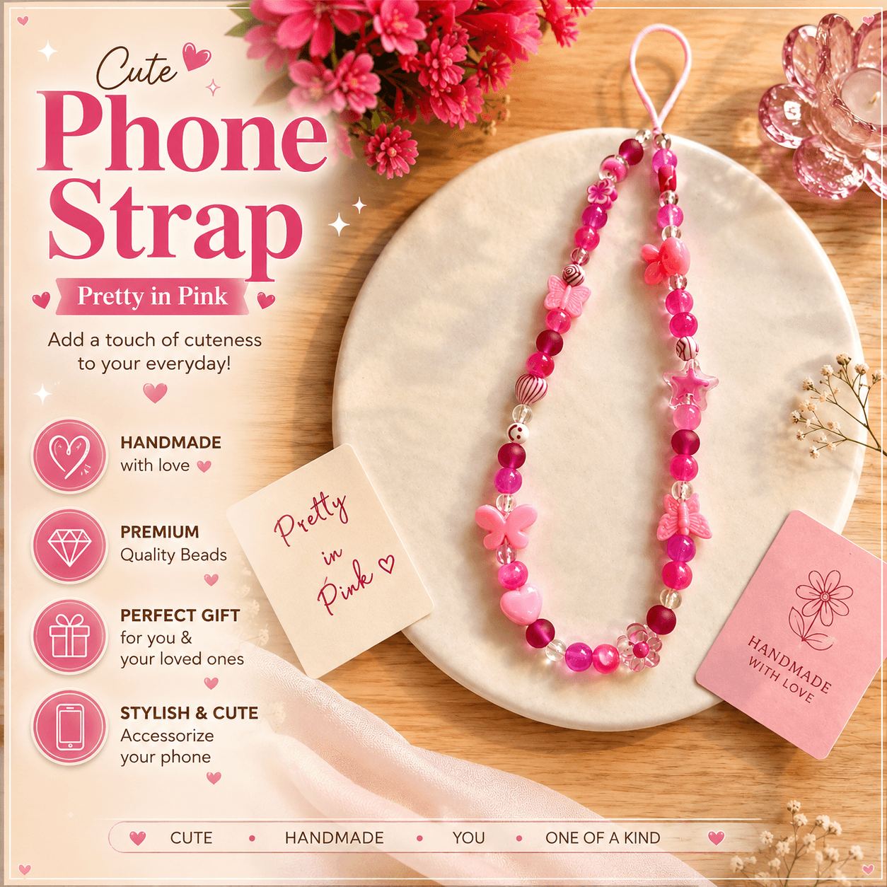 Handmade pink beaded phone strap displayed on a white plate with butterfly, flower, heart and star details.