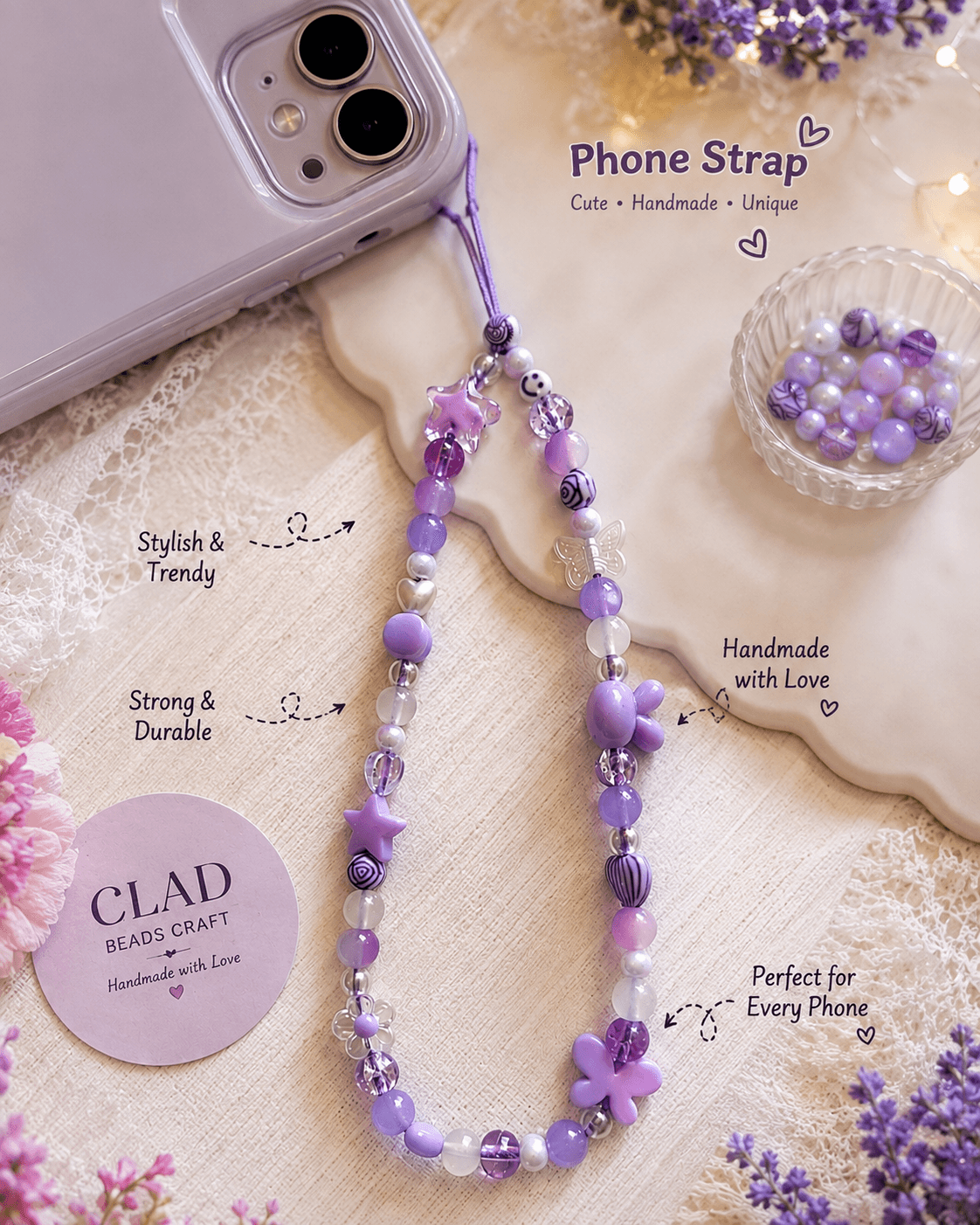 Purple handmade beaded phone strap with butterflies, star, flowers, teddy-bear-inspired and patterned beads attached to a clear phone case.