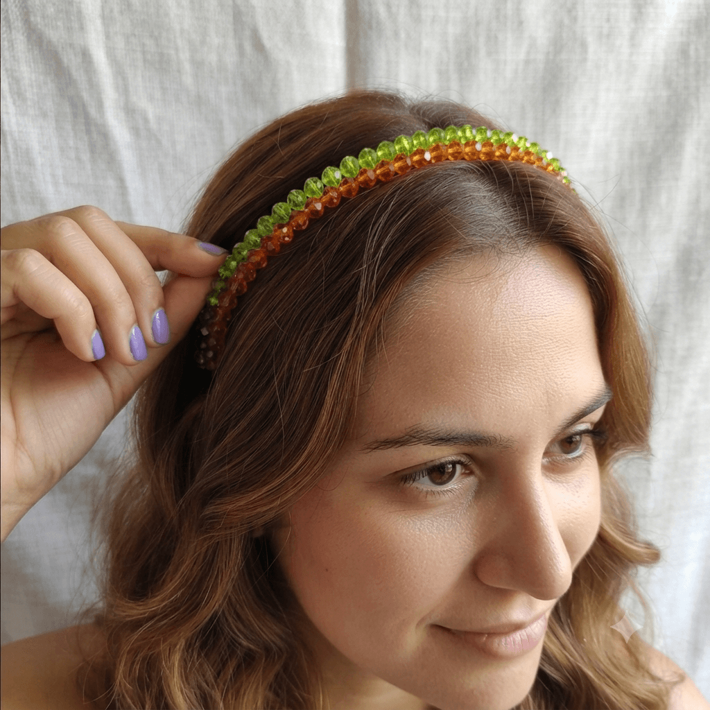 Woman wearing a green and orange faceted beaded headband