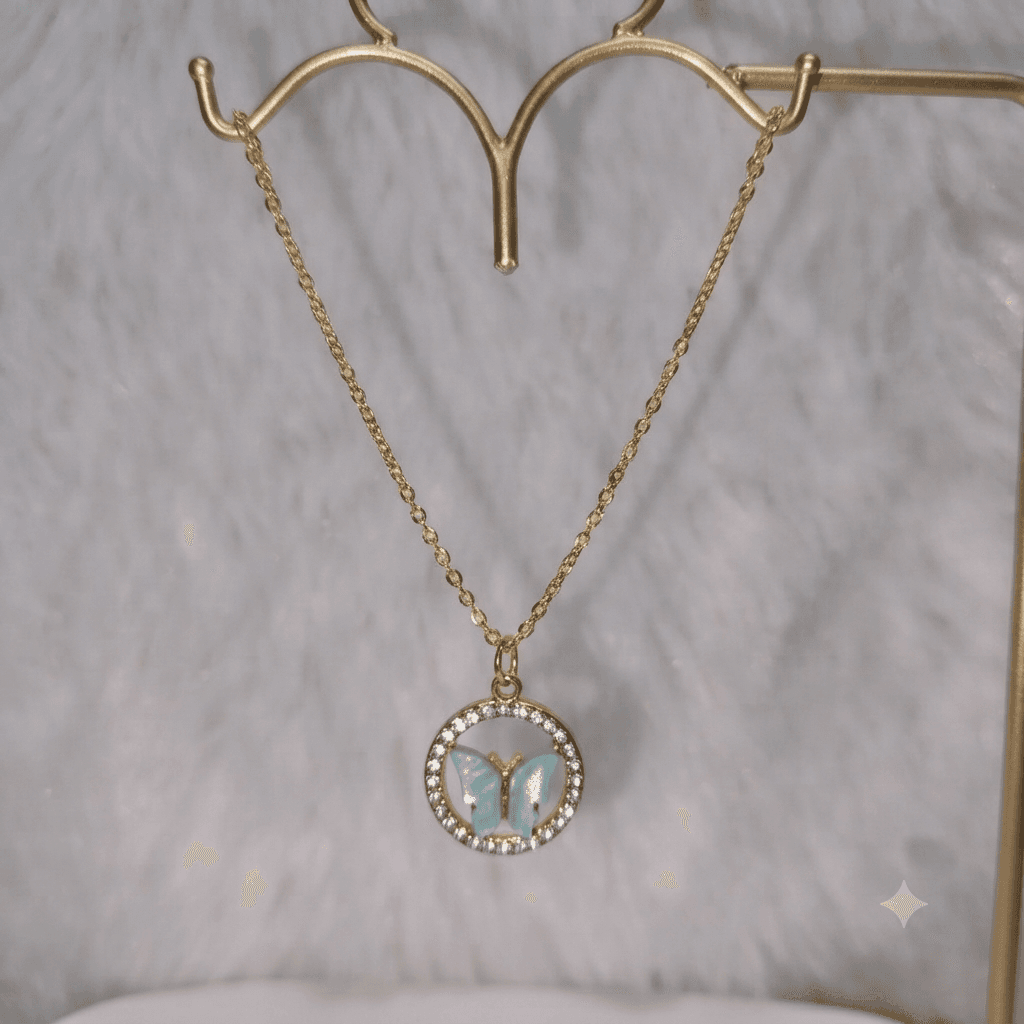 Aqua butterfly pendant necklace with gold-tone chain and sparkling circular frame