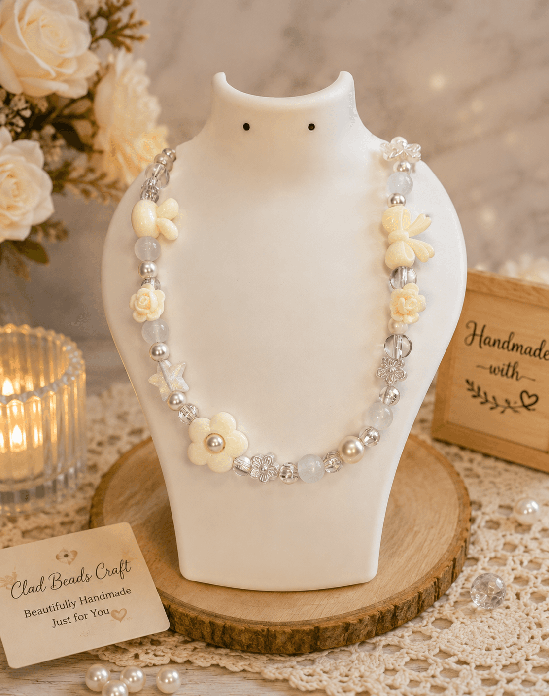 Ivory and cream handmade floral bead necklace displayed on a white jewellery bust